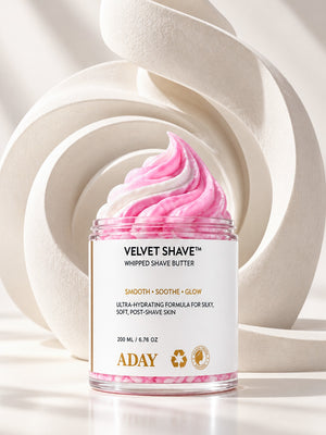 ADAY Velvet Shave Whipped Shave Butter in front of sculptural white arches