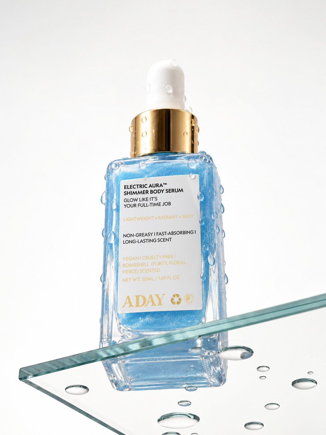 Electric Aura Shimmer Body Serum on a glass block
