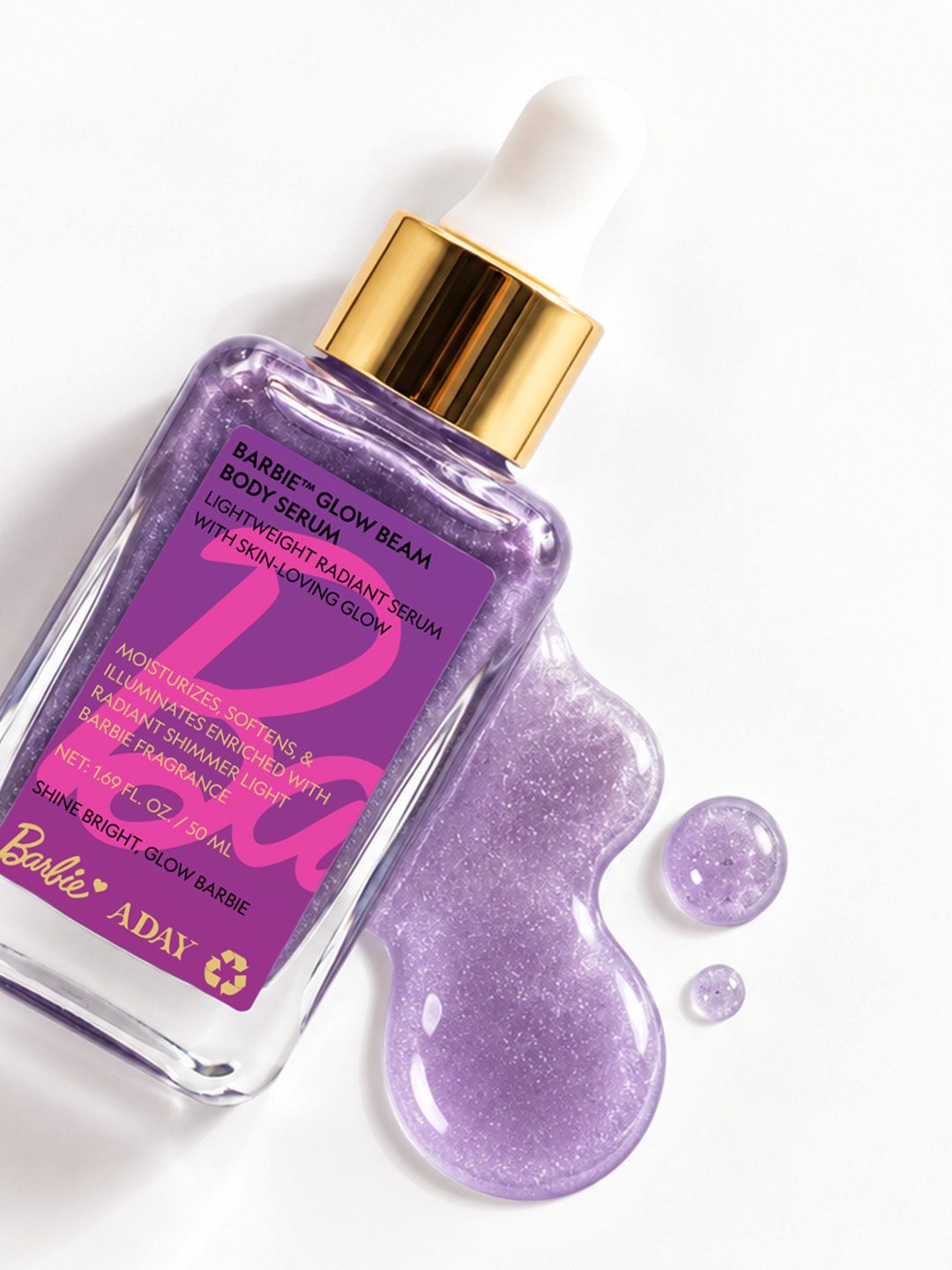 A pool of lilac shimmer serum beside the bottle