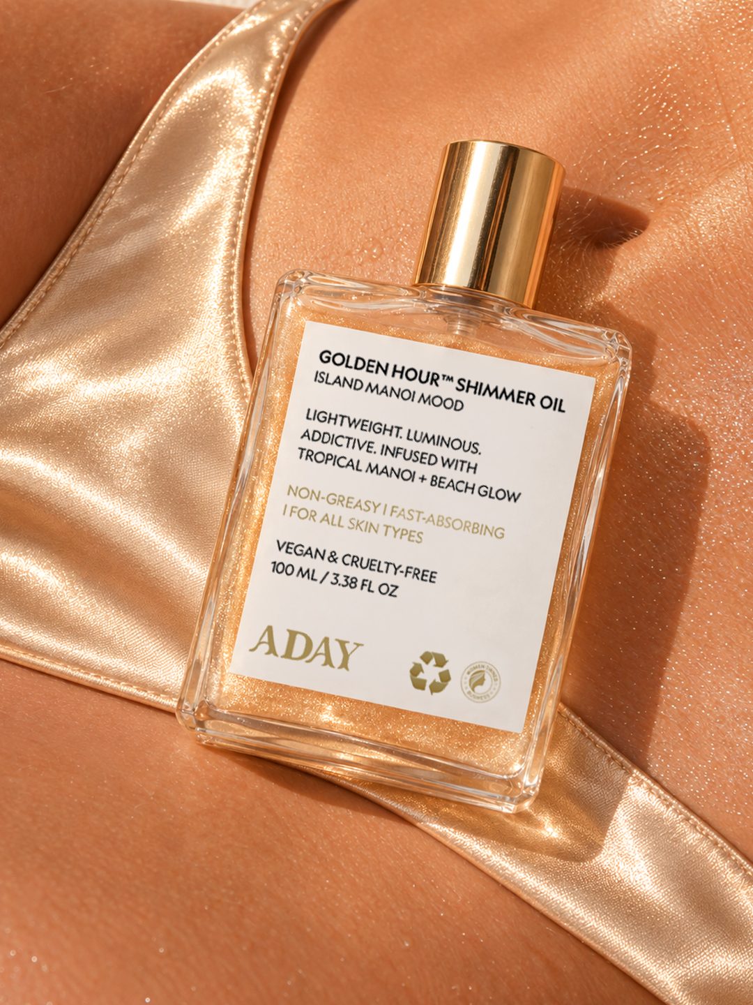 Golden Hour Shimmer Oil held against sunlit skin