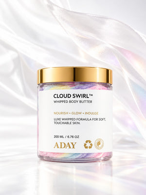 ADAY Cloud Swirl Whipped Body Butter with flowing silk behind it