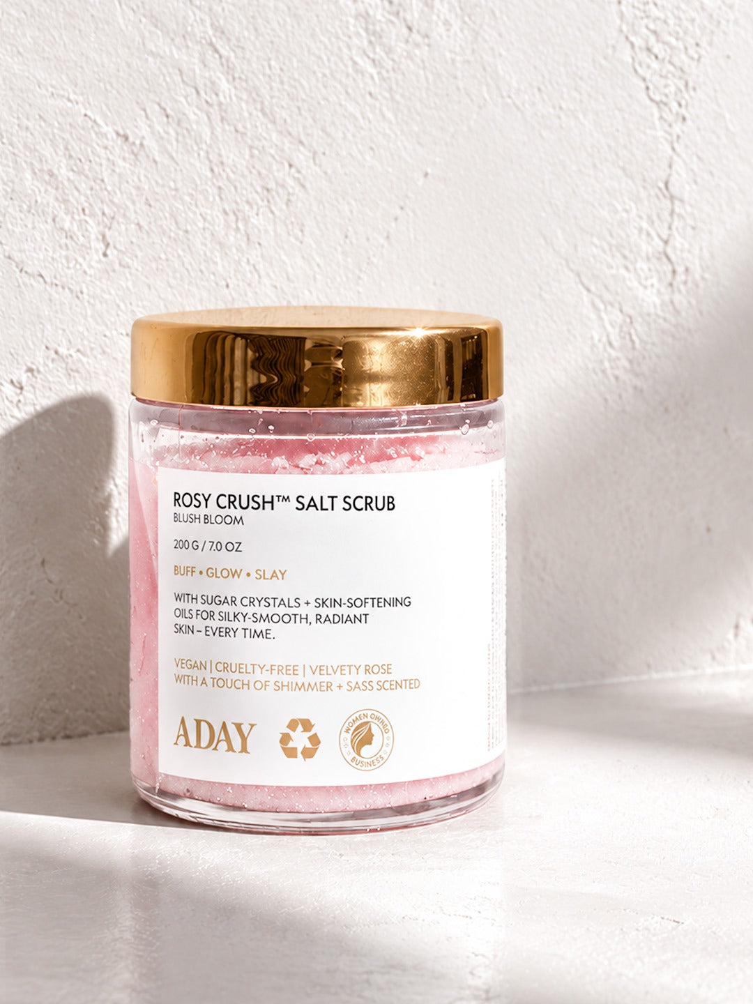 Scrub Trio: ADAY Rosy Crush Salt Scrub in Blush Bloom, a 200 g glass jar with a gold lid