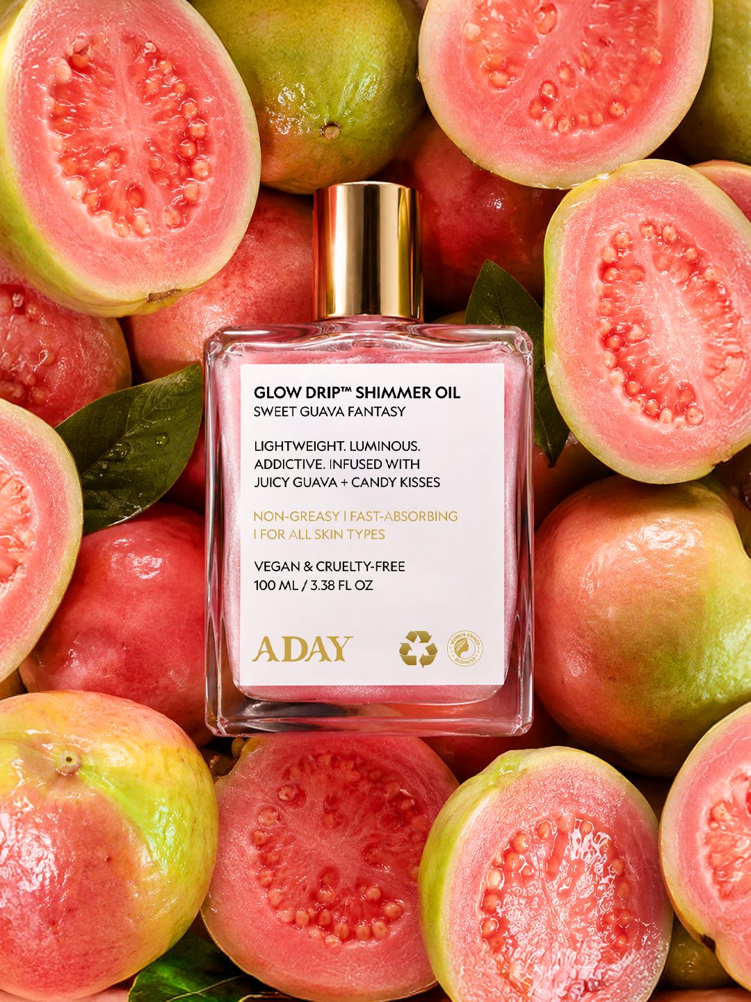 Glow Drip Shimmer Oil standing among sliced guavas