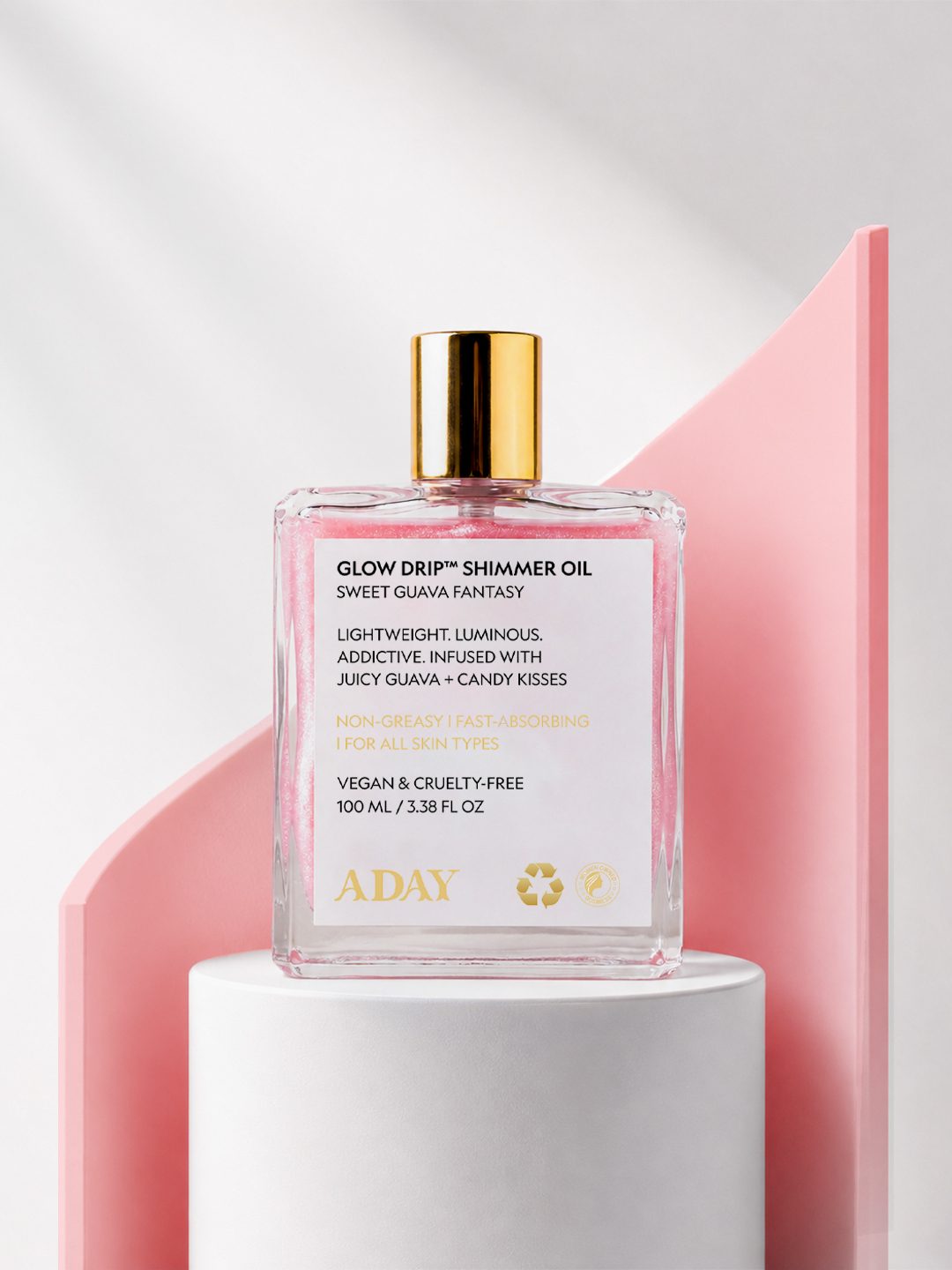 Glow Drip Shimmer Oil on a pink pedestal