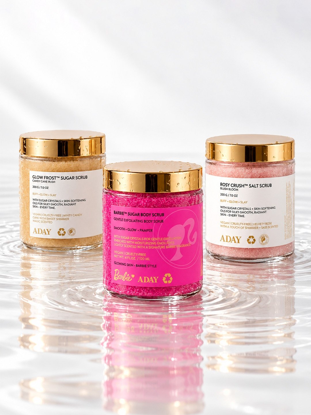 Three ADAY body scrubs together: Glow Frost, the ADAY x Barbie Sugar Scrub and Rosy Crush